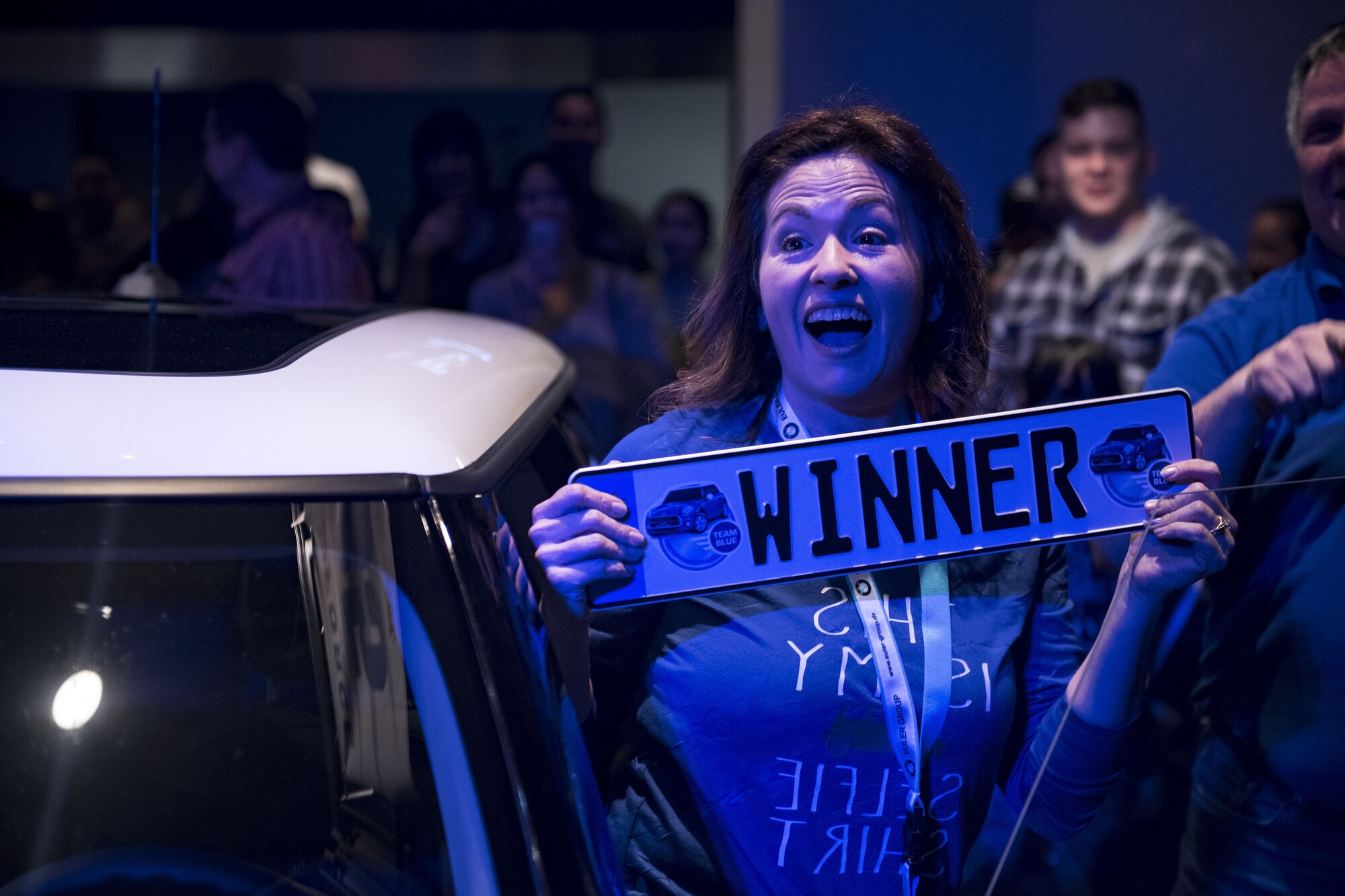 Yvonne Higby, Vogelweh Elementary School employee, holds a “winner” license plate during the 86th Force Support Squadron’s Year of Giving Back Finale at the Enlisted Club on Ramstein Air Base, Germany, Feb. 2, 2018. After winning the 2018 Mini Cooper, Higby described the feeling as overwhelming and thanked the 86th FSS for the gift. (U.S. Air Force photo by Senior Airman Devin Boyer)