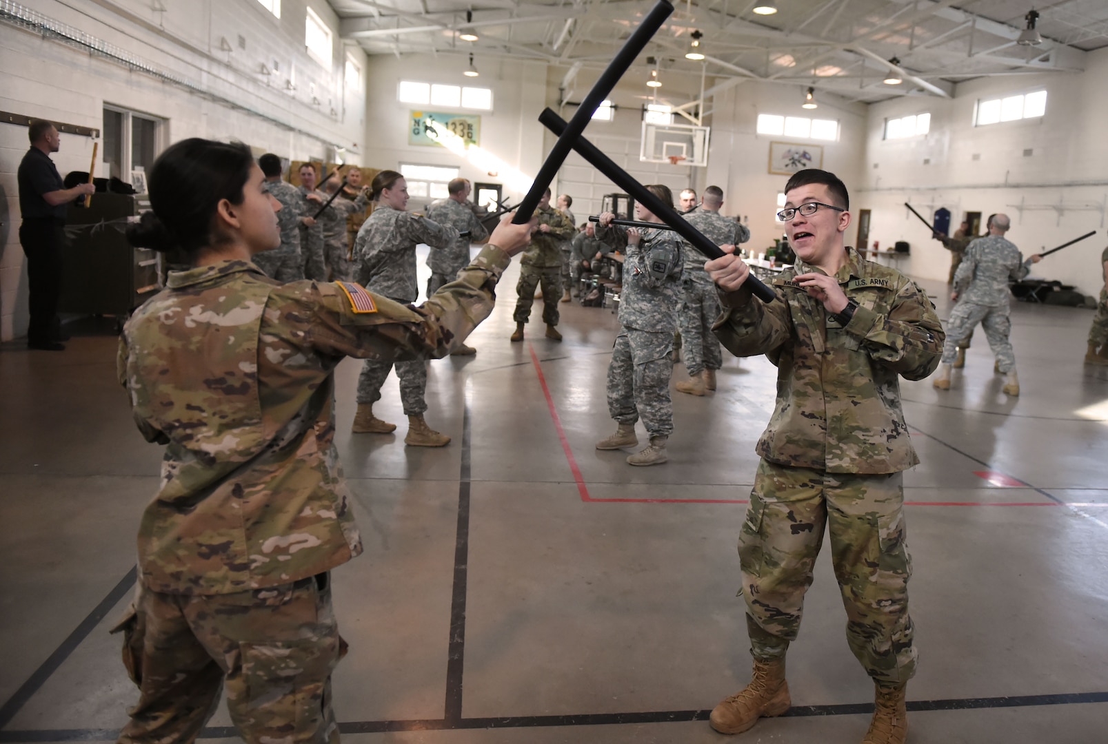 Pvt. Magdelena Corona and Pfc. Brock Munoz, assigned to the Wyoming Army National Guard 133rd Engineer Company, practice non-lethal baton techniques.