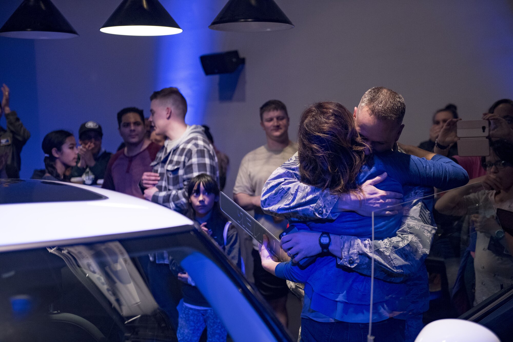 U.S. Air Force Chief Master Sgt. Micheal Higby, 86th Maintenance Group, embraces his wife Yvonne Higby, winner of a new 2018 Mini Cooper, during the 86th Force Support Squadron’s Year of Giving Back Finale at the Enlisted Club on Ramstein Air Base, Germany, Feb. 2, 2018. The event was the 86th and final event for the Year of Giving Back campaign. (U.S. Air Force photo by Senior Airman Devin Boyer)