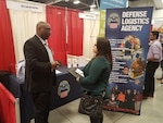 DLA Land and Maritime Recruiter, Carlton Edwards, speaks with a potential applicant.  Over 300 graduates attended the expo and most were looking for engineering positions