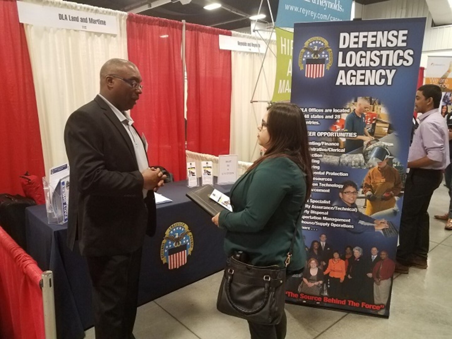 DLA Land and Maritime Recruiter, Carlton Edwards, speaks with a potential applicant.  Over 300 graduates attended the expo and most were looking for engineering positions