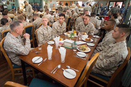 The Chairman of the Joint Chiefs of Staff meets with Marines during a meal in Australia.