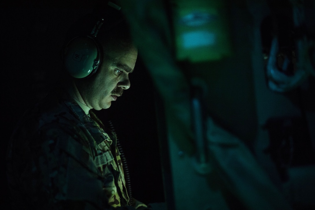 An airman looks down as he reads fro a laptop (not pictured).