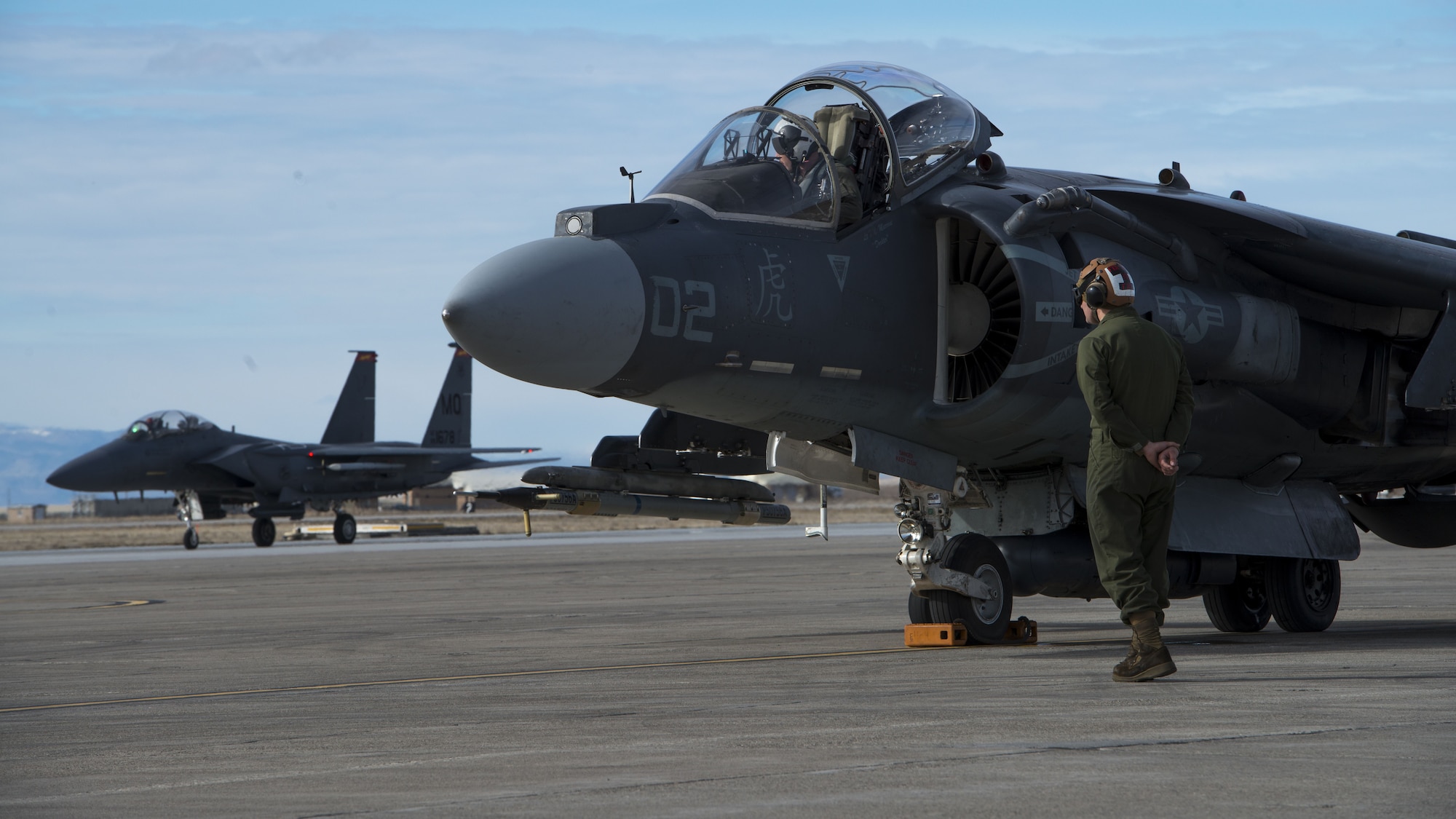 Corporal Tyler Fry, Marine Attack Squadron 542 powerline plane captain, conducts an AV-8B Harrier II pre-flight inspection Jan. 31, 2018, at Mountain Home Air Force Base, Idaho. The Marines worked alongside joint terminal attack controllers, F-15E Strike Eagles and A-10 Thunderbolt IIs to train under cold weather. (U.S. Air Force Photo by Airman 1st Class JaNae Capuno)