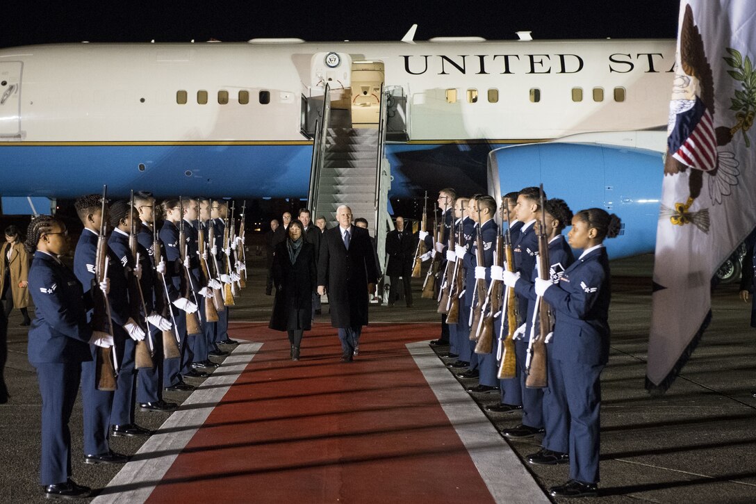 Vice President of the United States Michael R. Pence and wife Karen walk through a 374th Honor Guard cordon during his arrival at Yokota Air Base, Japan, Feb. 6, 2018.