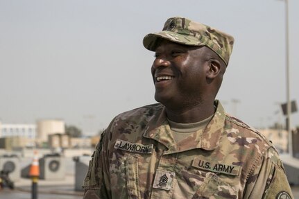 Sgt. Maj. Andre Lawhorn, 35th Infantry Division chemical, biological, radiological and nuclear sergeant major, enjoys a moment talking to his Soldiers during wash rack operations at Kuwait Naval Base.