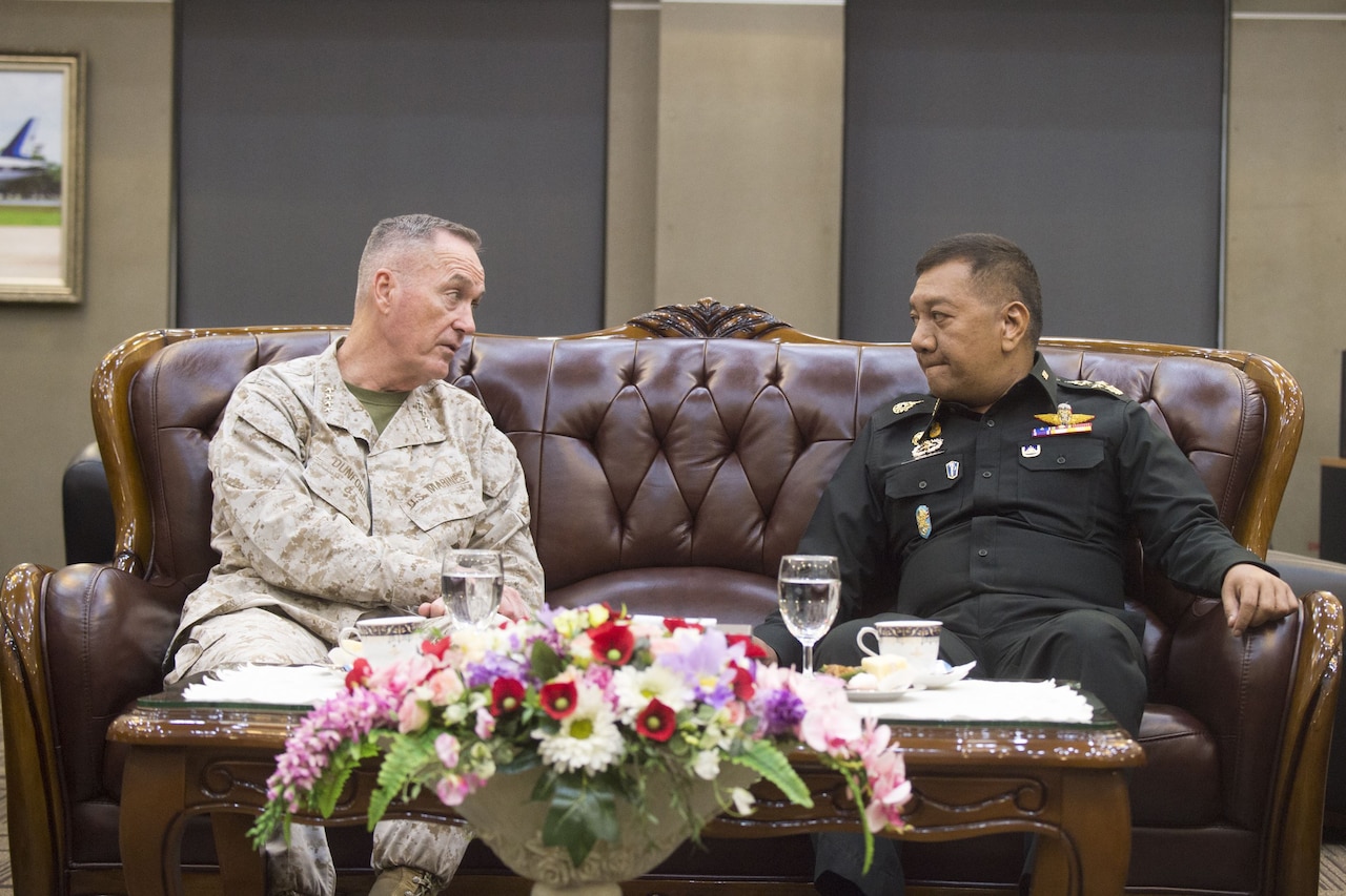 U.S and Thai defense leaders sit together and talk in Bangkok.