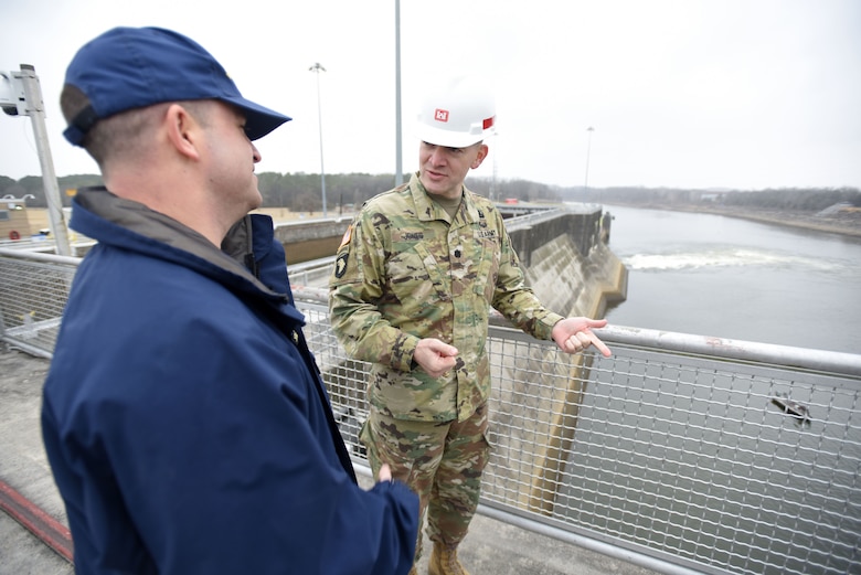 Lt. Col. Cullen Jones (Right), U.S. Army Corps of Engineers Nashville District commander, interacts with U.S. Coast Guard Lt. Pete McAndrew, U.S. Marine Safety Detachment in Nashville, during a tour on top of Old Hickory Dam on the Cumberland River in Old Hickory, Tenn.  They were participating in First Responders Day Feb. 1, 2018. (USACE photo by Lee Roberts)