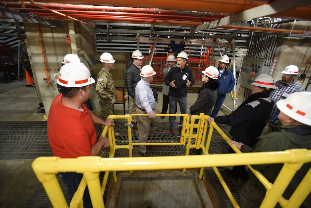 Joe Conatser (Holding Hands Up), U.S. Army Corps of Engineers Nashville District power plant manager at Old Hickory Dam, answers questions from a group of first responders in the hydropower plant during First Responders Day at the project on the Cumberland River in Old Hickory, Tenn., Feb. 1, 2018. (USACE photo by Lee Roberts)