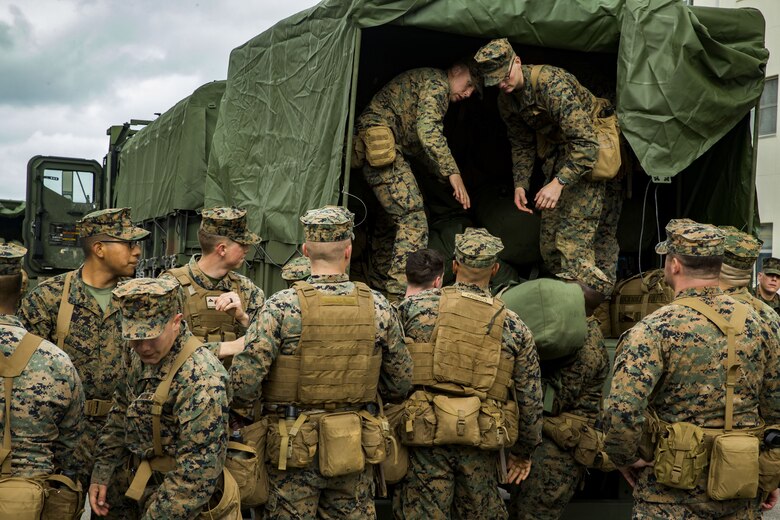 U.S. Marines with Headquarters and Service Company, 3rd Battalion, 3rd Marine Regiment, 3rd Marine Division, form a conveyer belt to load sea bags into the back of a 7ton truck in Okinawa, Japan, Feb. 1, 2018. The Marines are preparing to embark on the amphibious assault ship USS Bonhomme Richard (LHD-6) going to Thailand to participate in Exercise Cobra Gold 2018. Cobra Gold 18 is an annual exercise conducted in the Kingdom of Thailand and runs from Feb. 13-23 with seven full participating nations.