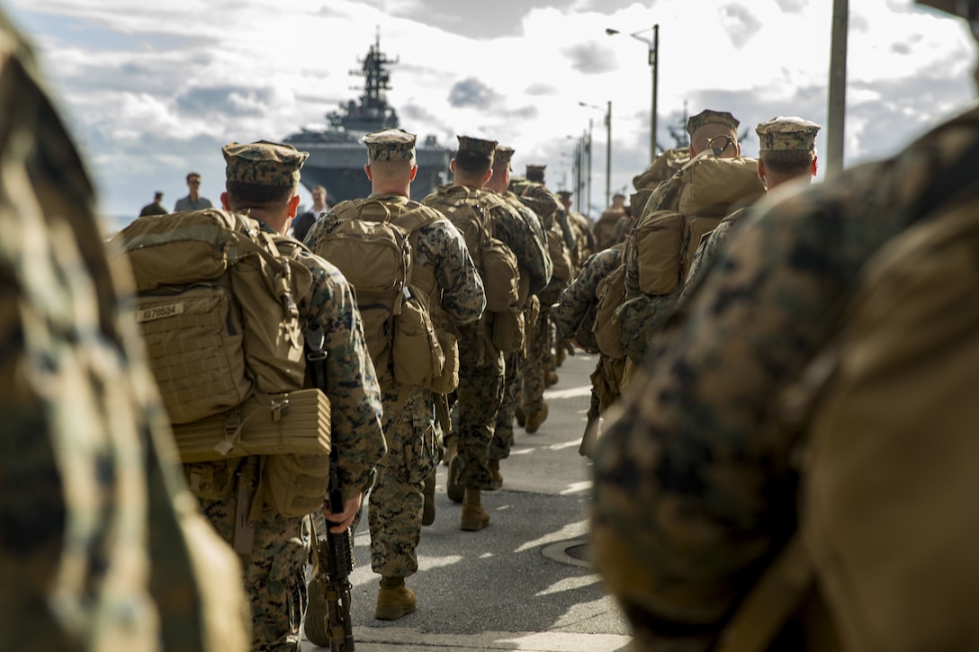 U.S. Marines with Headquarters and Service Company, 3rd Battalion, 3rd Marine Regiment, 3rd Marine Division, march on the pier towards the amphibious assault ship USS Bonhomme Richard (LHD-6) in Okinawa, Japan, Feb. 1, 2018. The Marines are preparing to embark on the USS Bonhomme Richard going to Thailand to participate in Exercise Cobra Gold 2018. Cobra Gold 18 is an annual exercise conducted in the Kingdom of Thailand and runs from Feb. 13-23 with seven full participating nations.