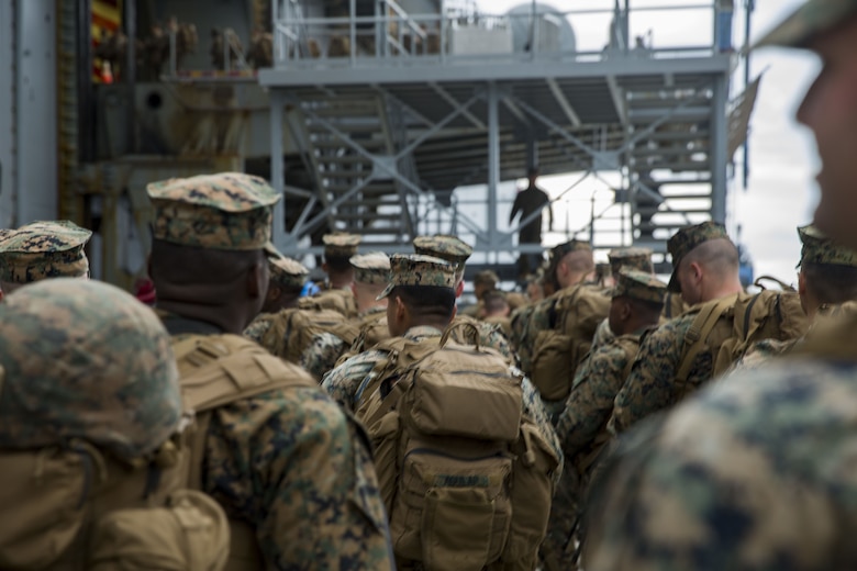 U.S. Marines with Headquarters and Service Company, 3rd Battalion, 3rd Marine Regiment, 3rd Marine Division, wait for their turn to board the amphibious assault ship USS Bonhomme Richard (LHD-6) in Okinawa, Japan, Feb. 1, 2018. The Marines are preparing to embark on the USS Bonhomme Richard going to Thailand to participate in Exercise Cobra Gold 2018. Cobra Gold 2018 is an annual exercise conducted in the Kingdom of Thailand and runs from Feb. 13-23 with seven full participating nations.