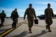 Pilots, maintainers walk along the flight line, Jan. 16, 2018, at Moody Air Force Base, Ga.  From 16-25 Jan., Airmen from the 723d AMXS performed 216 hours of maintenance on an HH-60 after it returned to Moody following 350 days of depot maintenance at Naval Air Station (NAS) Jacksonville. While at NAS Jacksonville, the HH-60 underwent a complete structural overhaul where it received new internal and external components along with repairs and updated programming. 
(U.S. Air Force photo by Airman 1st Class Erick Requadt)