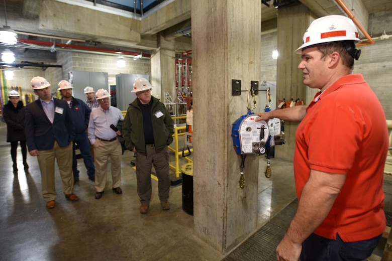 Mike Corcoran (Red Shirt), mechanic at the Old Hickory Dam Hydropower Plant, leads participants of First Responders Day during a tour of the project on the Cumberland River in Hendersonville, Tenn., Feb. 1, 2018. (USACE photo by Leon Roberts)