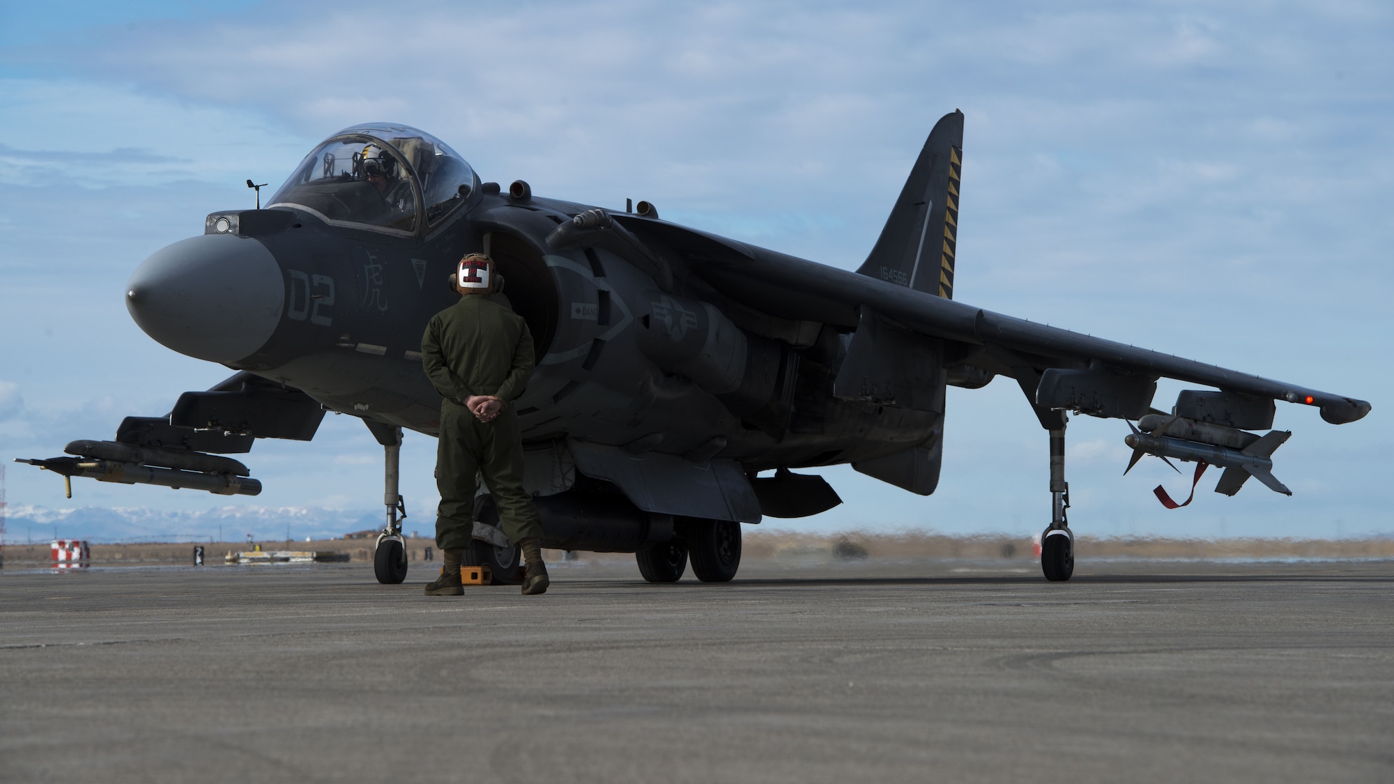 Corporal Tyler Fry, Marine Attack Squadron 542 powerline plane captain, walks around an AV-8B Harrier II during a pre-flight inspection Jan. 31, 2018, at Mountain Home Air Force Base, Idaho. Working in cold weather conditions and side-by-side with the Air Force will help VMA-542 train for its mission. (U.S. Air Force Photo by Airman 1st Class JaNae Capuno)