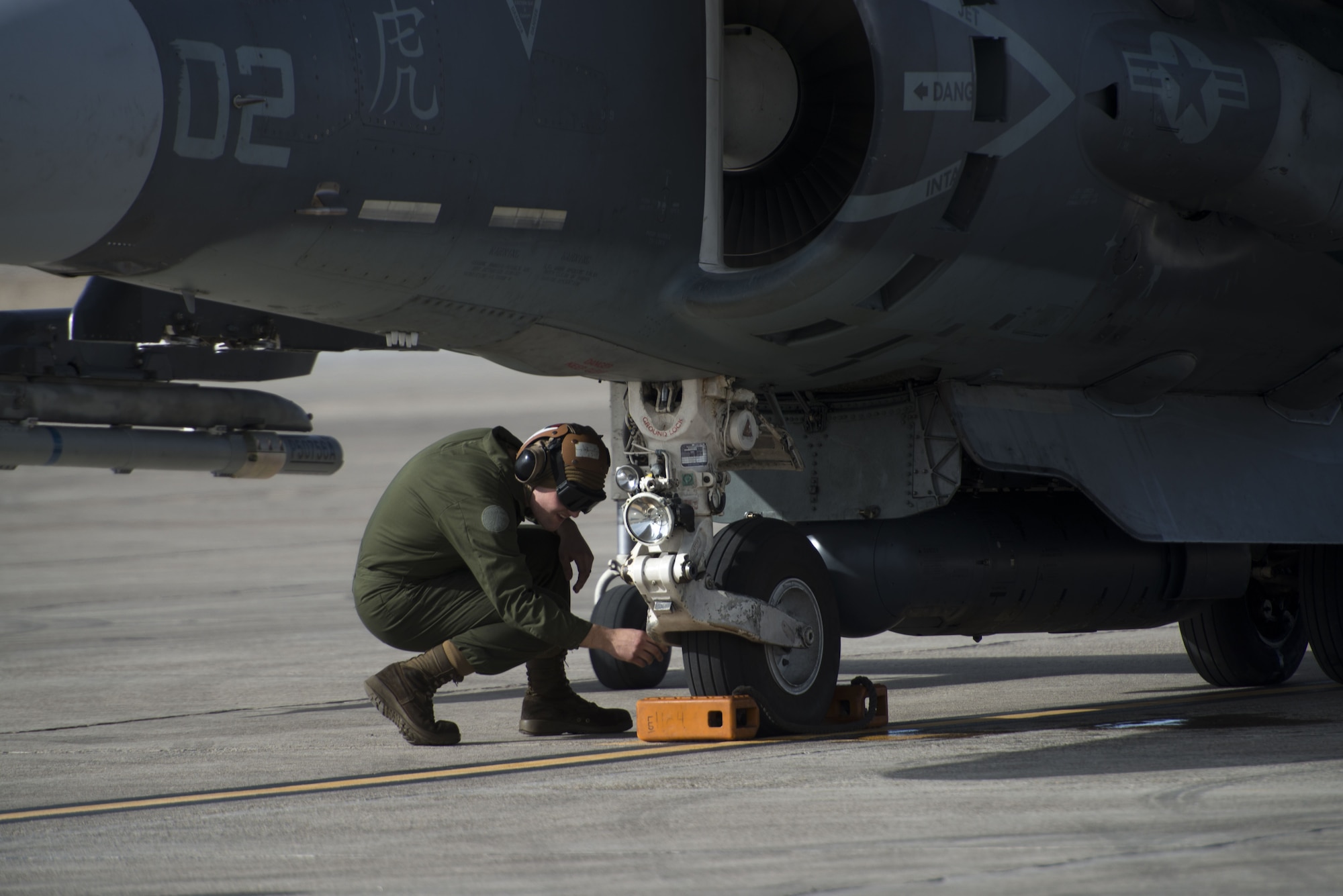 Corporal Tyler Fry, Marine Attack Squadron 542 powerline plane captain, inspects the landing gear of an AV-8B Harrier II during a pre-flight inspection Jan. 31, 2018, at Mountain Home Air Force Base, Idaho. The VMA-542 is stationed at Marine Corps Air Station Cherry Point, North Carolina. (U.S. Air Force Photo by Airman 1st Class JaNae Capuno)