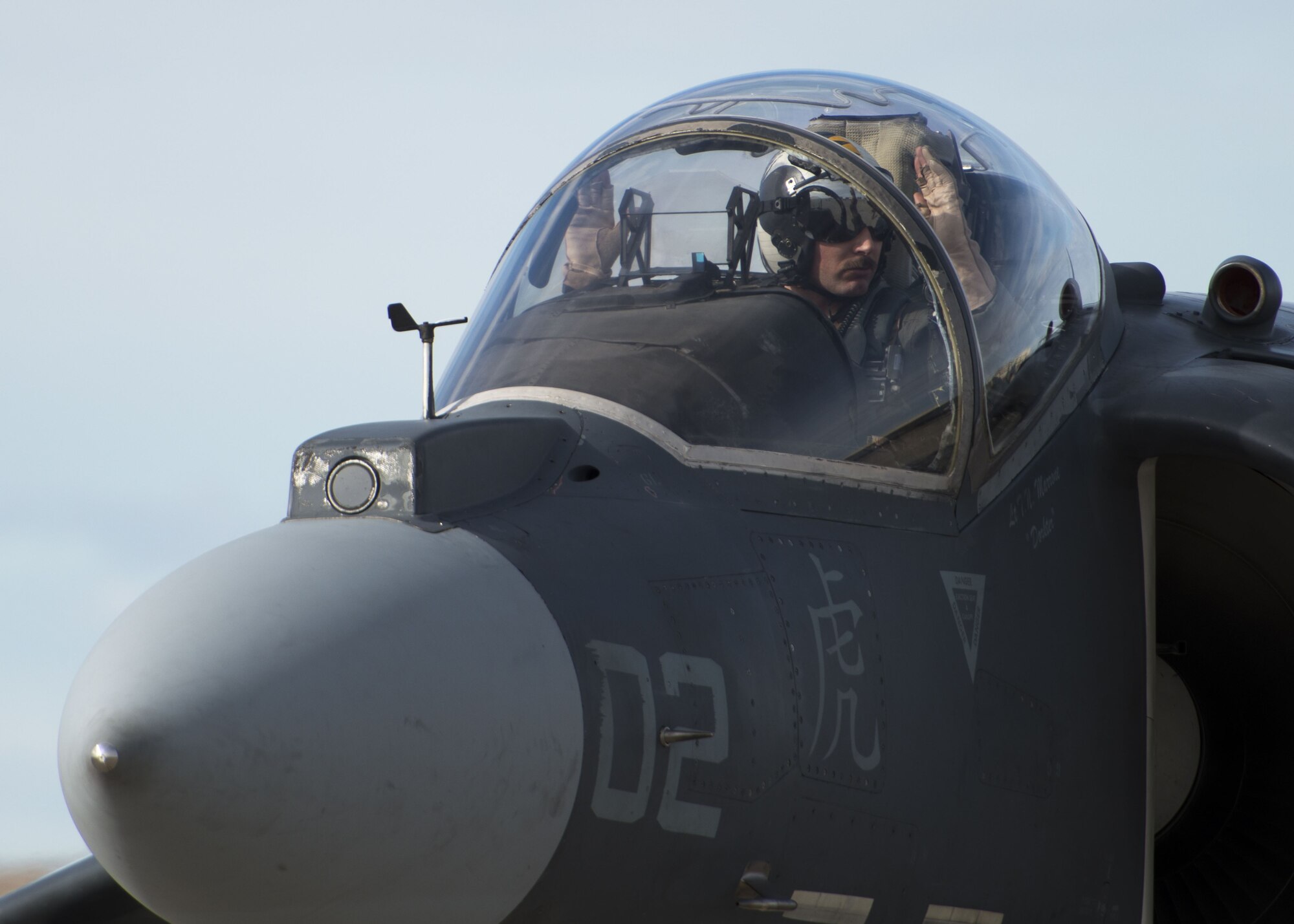 A Marine Attack Squadron 542 AV-8B Harrier II pilot gives hand signals during a pre-flight inspection Jan. 31, 2018, at Mountain Home Air Force Base, Idaho. The VMA-542 trained with the 366th Fighter Wing to experience mission operations under cold weather. (U.S. Air Force Photo by Airman 1st Class JaNae Capuno)