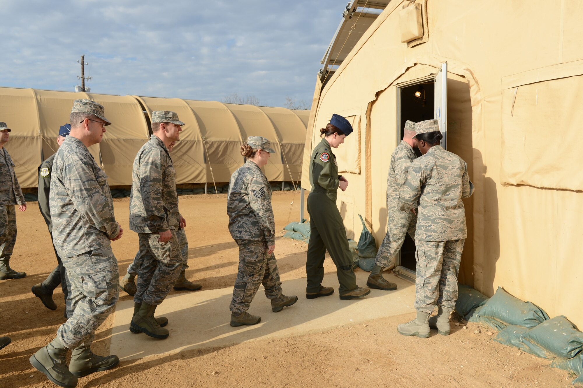 Members of the 62nd Airlift Wing command staff walk into a tent January 11, 2018, at the Basic Expeditionary Airman Skills Training site on the Medina Annex of Joint Base San Antonio, Texas