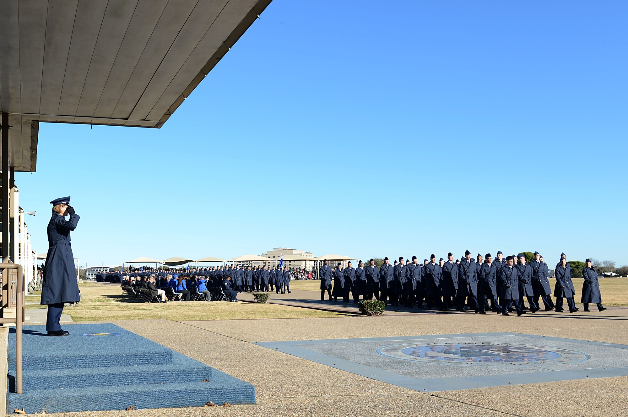 Col. Rebecca Sonkiss, 62nd Airlift Wing commander, returns a salute from graduating Airmen and their Military Training Instructors during a graduation parade, January 12, 2018, at Joint Base San Antonio, Texas.