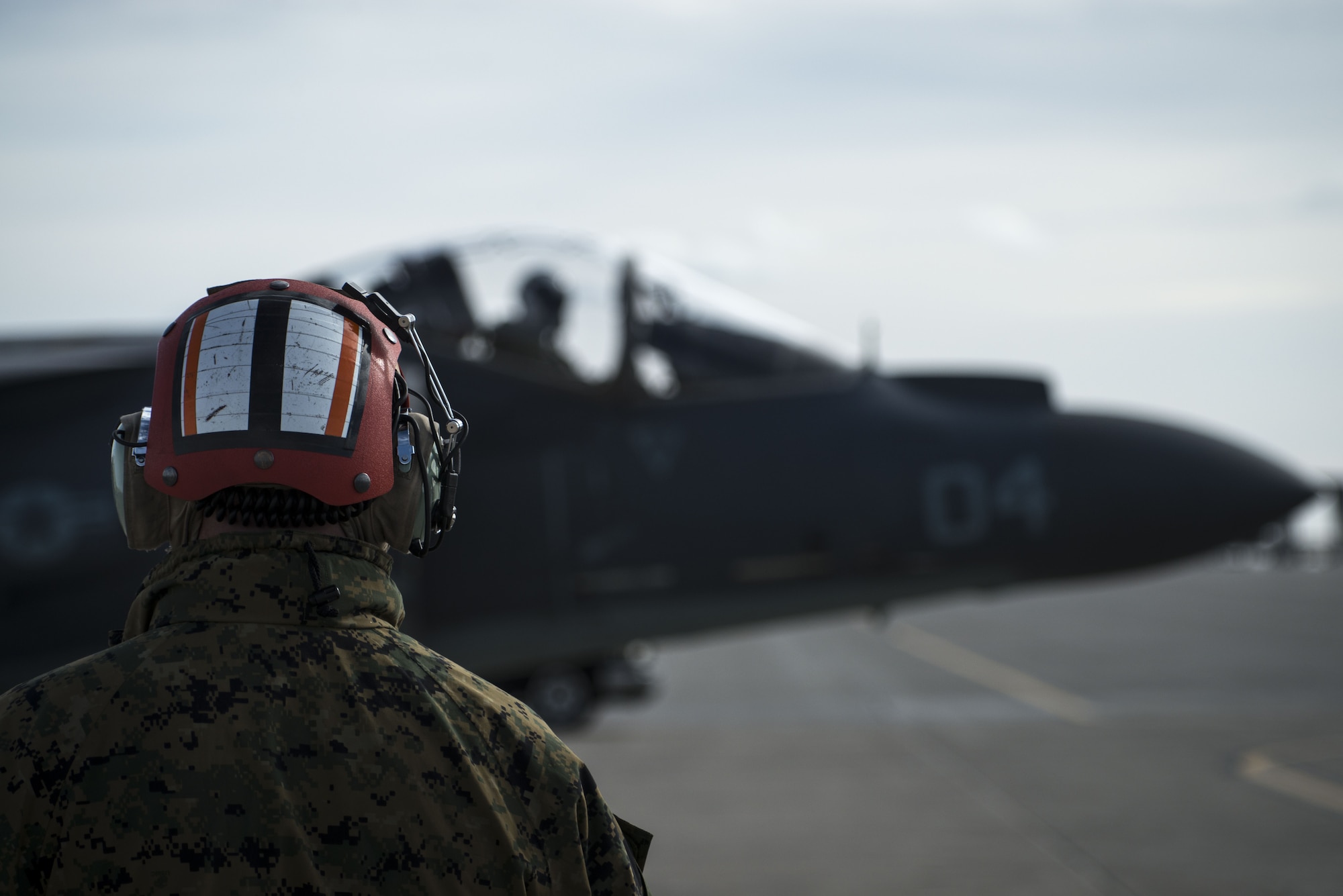 Chief Warrant Officer 2 Alex Harer, Marine Attack Squadron 542 ordinance officer in charge, oversees an AV-8B Harrier II taxing to the runway Jan. 31, 2018, at Mountain Home Air Force Base, Idaho. The Marine Attack Squadron 542 worked alongside joint terminal attack controllers, F-15E Strike Eagles and A-10 Thunderbolt IIs. (U.S. Air Force Photo by Airman 1st Class JaNae Capuno)