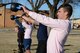 Senior Airman Michael Fenn, along with several of his classmates from Airman Leadership School Class 18-A, do kettle bell swings as part of their PT exercises.