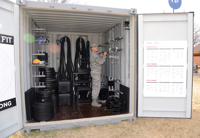 Tech. Sgt. Ricky Dent, an instructor at Tinker's Airman Leadership School, organizes the equipment inside the Combat Cube, which houses 2,000 pounds of weights, battle ropes, medicine balls and kettle bells, jump ropes, weight bars, stands, resistance bands and weighted sleds.