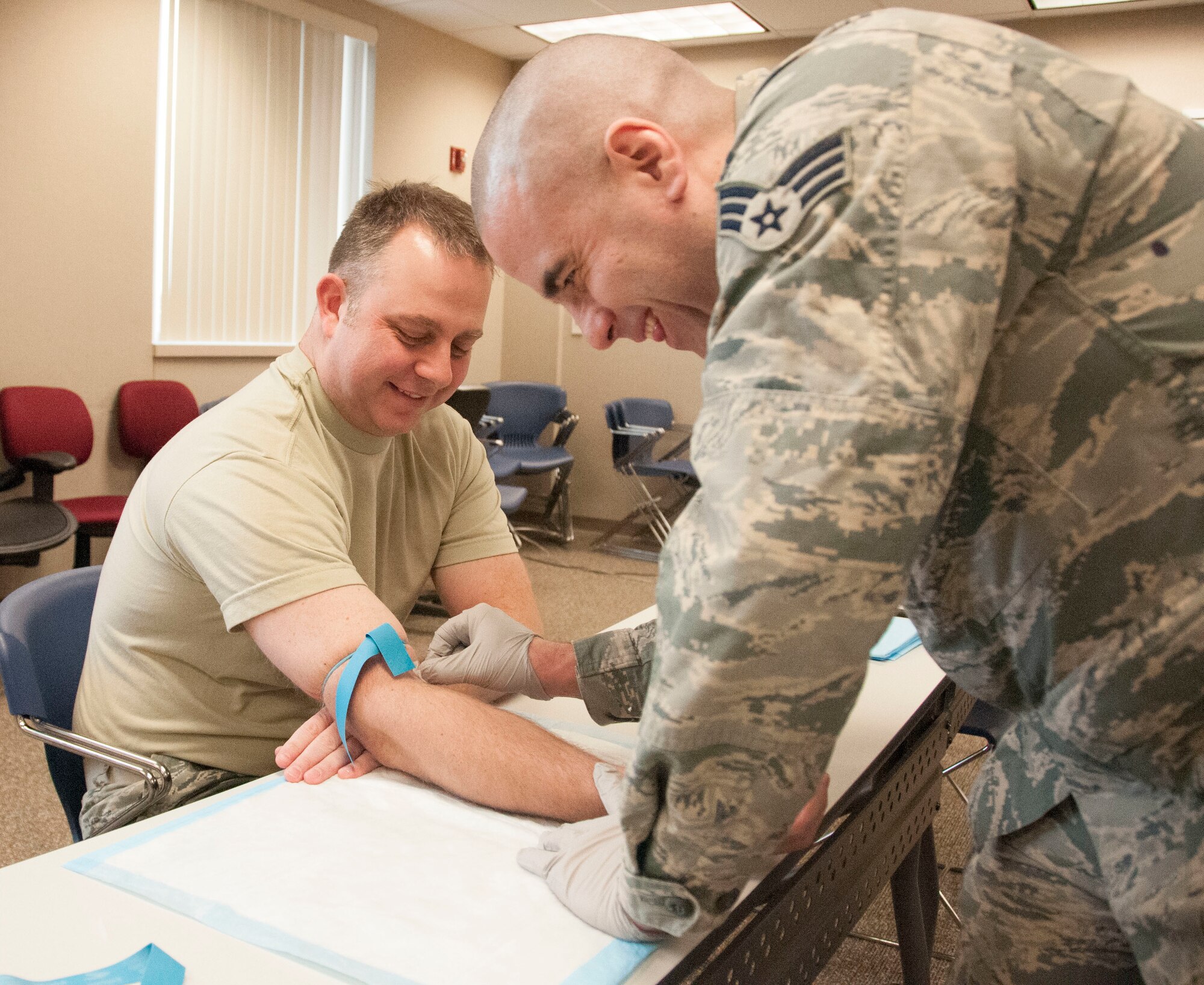 Tech. Sgt. Brett Haas of the 127th Maintenance Operation Flight receives a routine blood draw from Senior Airman Rick Burnett an aerospace medical technician with the 127th Medical Group on February 3,2018. Military members are required to fulfill mandated medical requirements annually to ensure readiness to deploy worldwide.