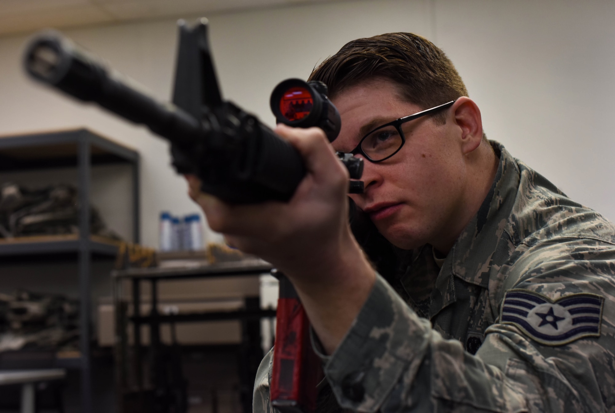 Staff Sgt. John A. Lucic, 62nd Maintenance Squadron unit training manager, looks through the scope of an M-4 carbine during the 627th Security Forces Squadron’s Combat Arms Training and Maintenance class at Joint Base Lewis-McChord, Wash., Jan. 31, 2018.