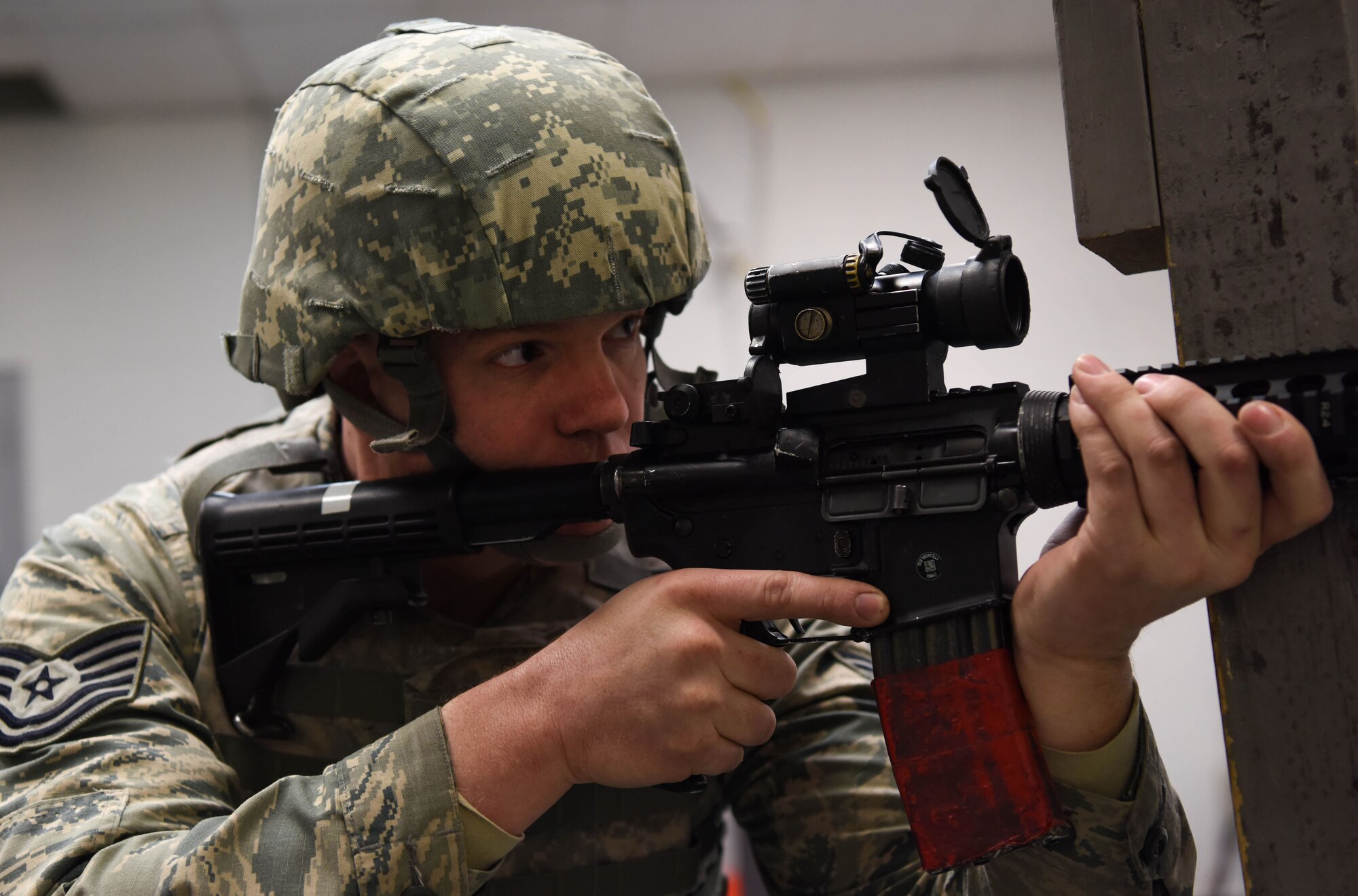 Tech. Sgt. Christopher Groessler, 62nd Maintenance Squadron munitions technician, practices kneeling behind a barricade during the 627th Security Forces Squadron’s Combat Arms Training and Maintenance class at Joint Base Lewis-McChord, Wash., Jan. 31, 2018.