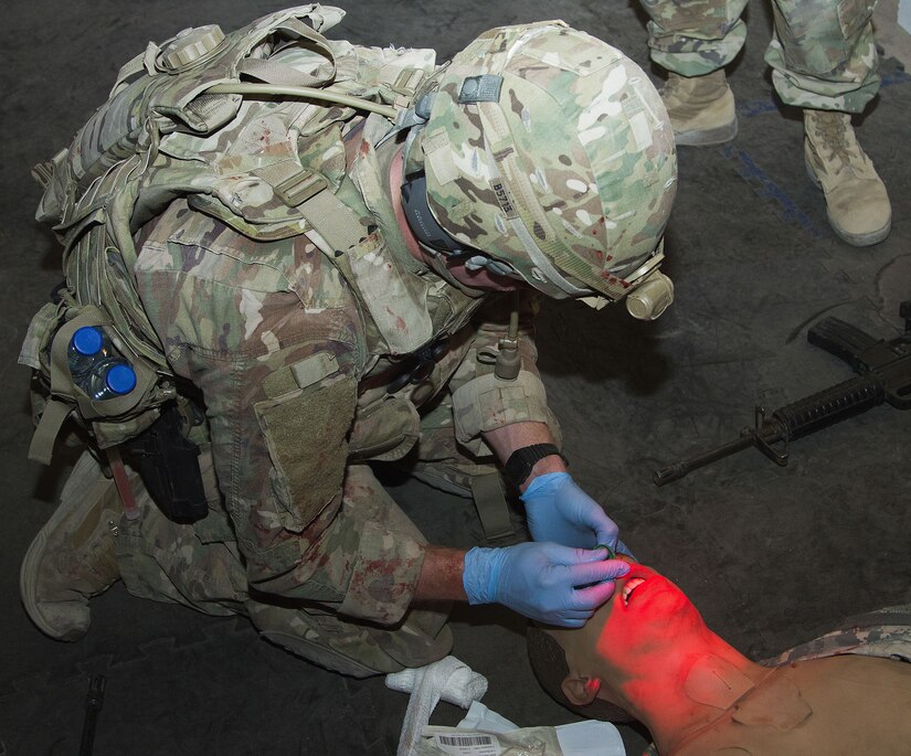 Soldier treats simulated casualty for training