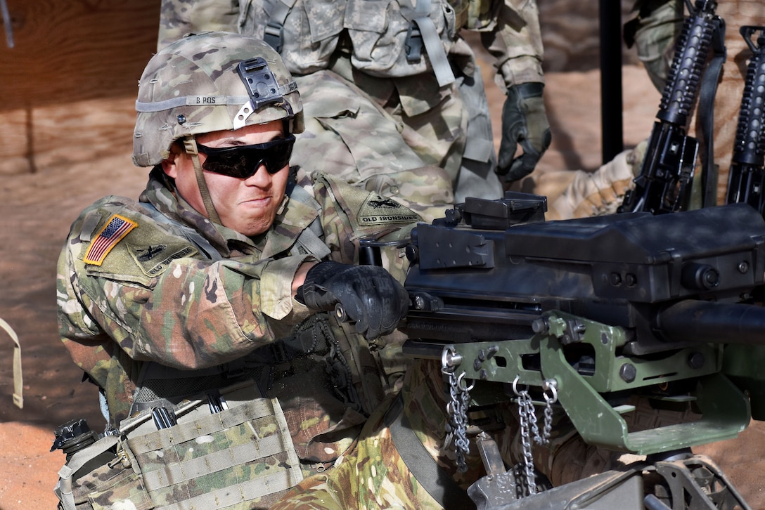 A soldier shoots an MK19 grenade launcher.