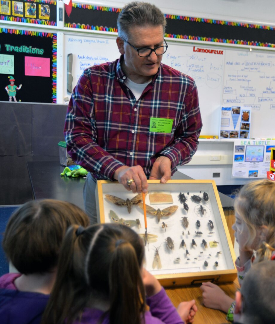 Dr. William Miller, U.S. Army Environmental Command entomologist, shows a display case of insects to second graders in the gifted and talented program at Fort Sam Houston Elementary School Jan. 31.