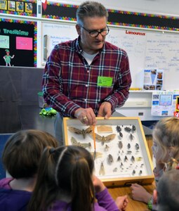 Dr. William Miller, U.S. Army Environmental Command entomologist, shows a display case of insects to second graders in the gifted and talented program at Fort Sam Houston Elementary School Jan. 31.