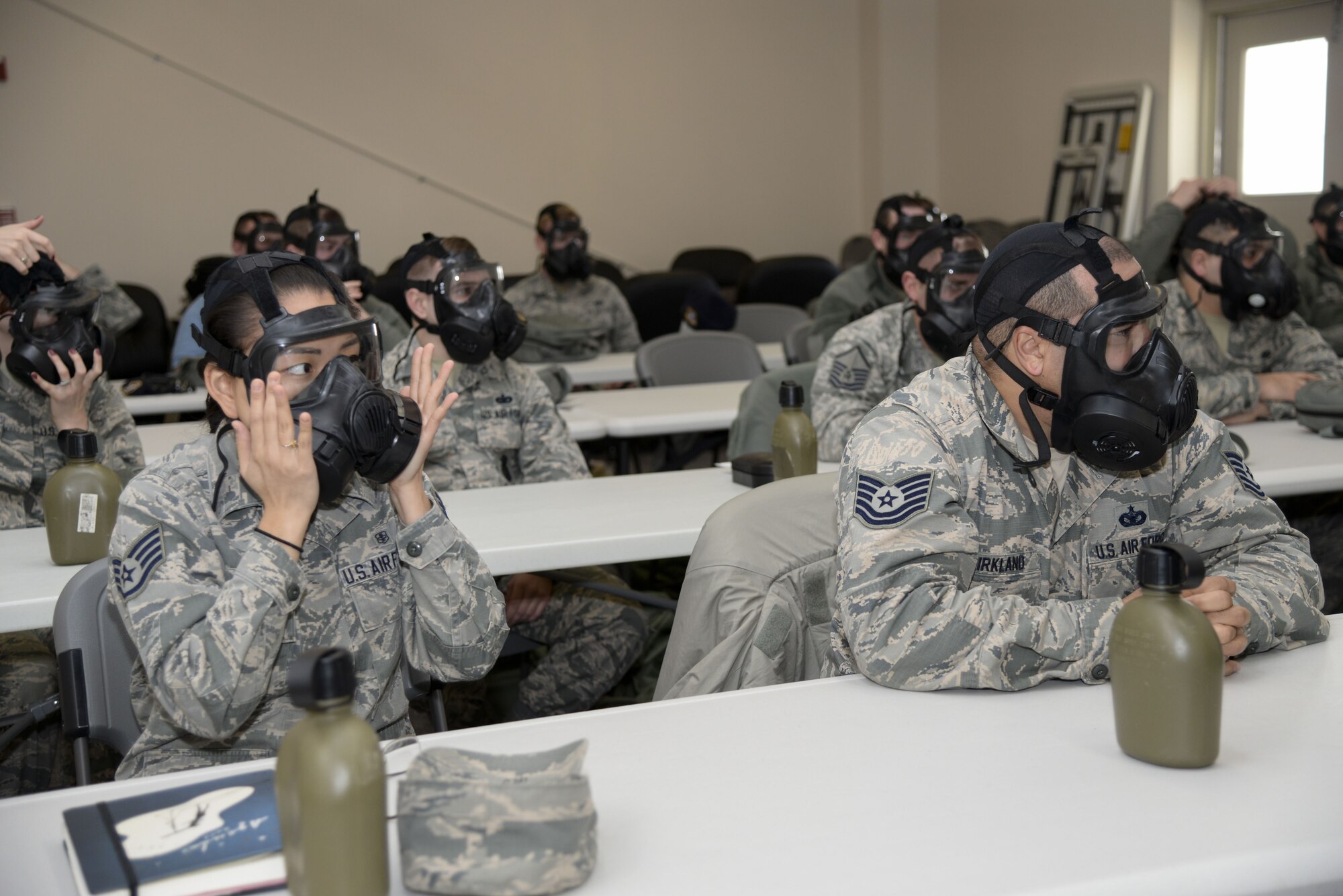 Team Dover Airmen don gas masks during a Chemical, Biological, Radiological and Nuclear (CBRN) training session Jan. 31, 2018, at Dover Air Force Base, Del. During the training, Airmen were taught how to properly wear their gas mask and how to test for a good seal. (U.S. Air Force photo by Staff Sgt. Aaron J. Jenne)