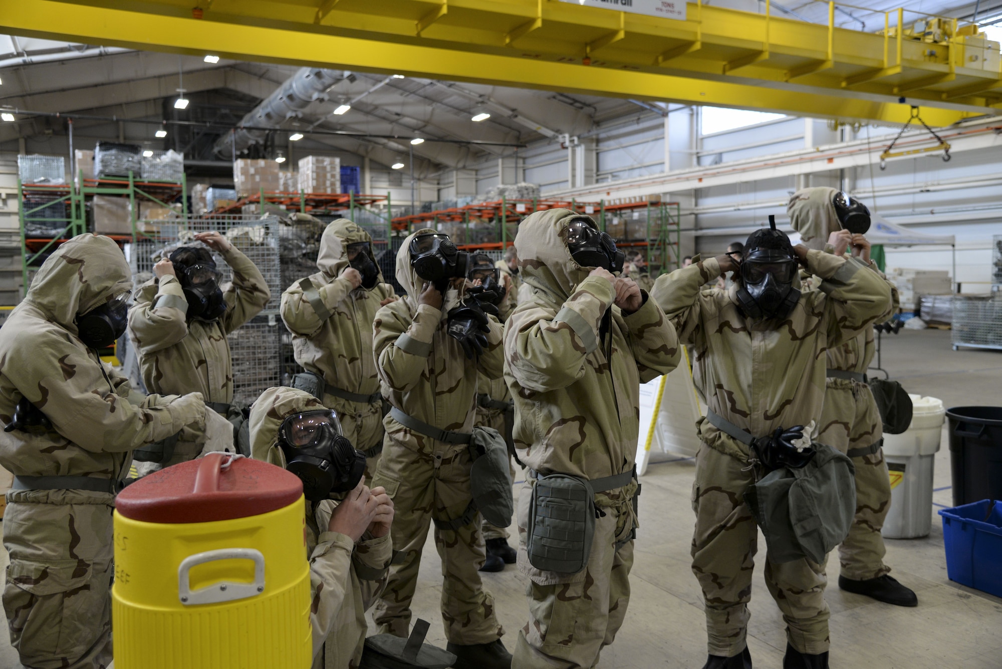 Team Dover Airmen don Mission Oriented Protective Posture, also known as MOPP gear, during a Chemical, Biological, Radiological and Nuclear (CBRN) training session Jan. 31, 2018, at Dover Air Force Base, Del. During a chemical attack, service members have only moments to don their individual protective equipment. (U.S. Air Force photo by Staff Sgt. Aaron J. Jenne)