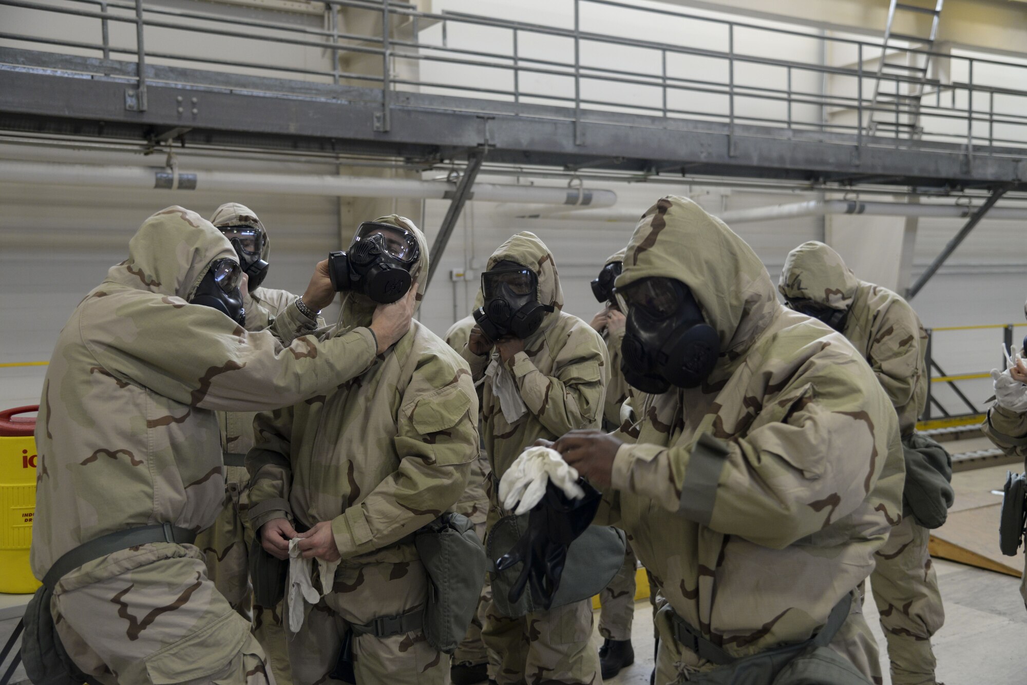 Col. Ethan Griffin, 436th Airlift Wing commander, (far left) performs a buddy check of another Airman’s Mission Oriented Protective Posture, also known as MOPP gear, during a Chemical, Biological, Radiological and Nuclear (CBRN) training session Jan. 31, 2018, at Dover Air Force Base, Del. When worn properly, MOPP gear provides an airtight seal, completely encapsulating the wearer. (U.S. Air Force photo by Staff Sgt. Aaron J. Jenne)