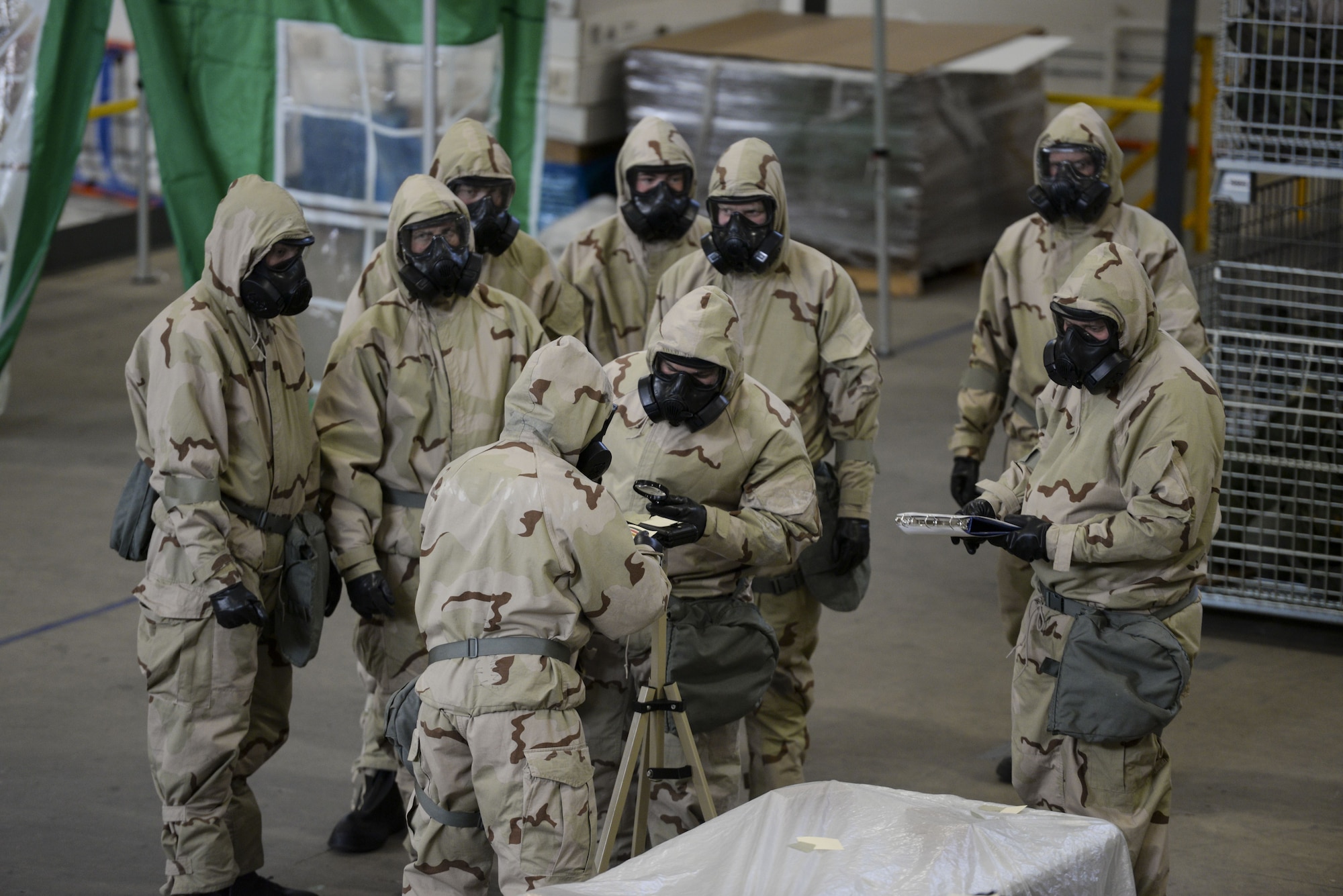 Team Dover Airmen inspect M8 chemical detection paper for recorded contaminants during a Chemical, Biological, Radiological and Nuclear (CBRN) training session Jan. 31, 2018, at Dover Air Force Base, Del. The detection paper changes colors to indicate exposure to nerve or blister chemical agents, warning service members of contaminated environments. (U.S. Air Force photo by Staff Sgt. Aaron J. Jenne)