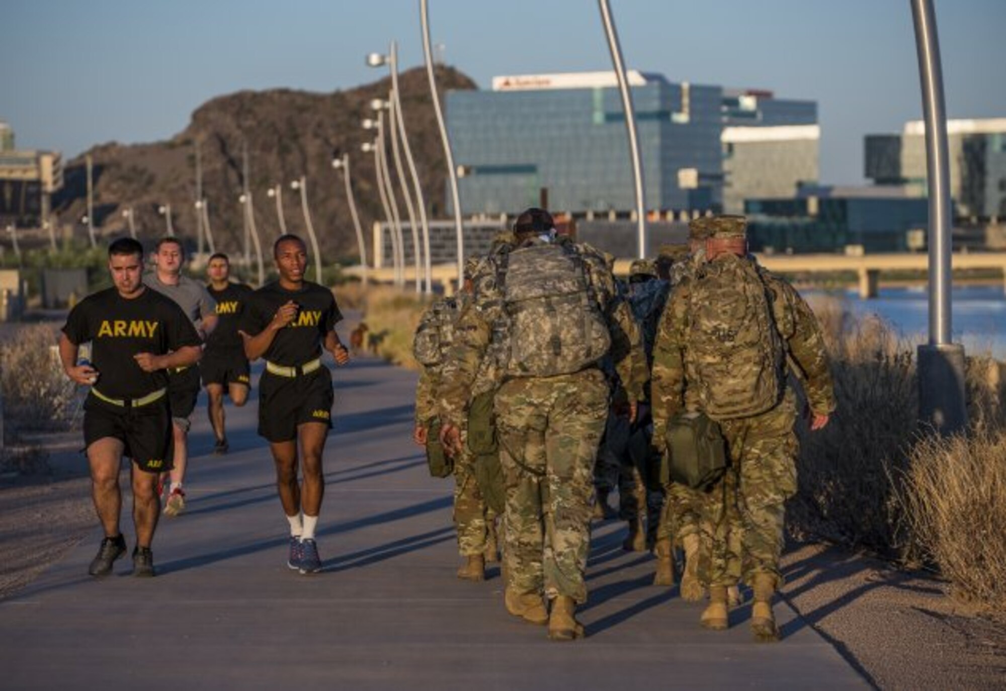 A group of U.S. Army Reserve Soldiers from the 387th Military Police Battalion run past a group of command sergeants major from across the 200th Military Police Command participating in a team-building ruck march during a "CSM Huddle" in Scottsdale, Arizona, Sept. 16, 2017. DOD is evaluating further guidance for the use of fitness trackers used in Soldiers' physical fitness activities after reports of "heat maps" that can track Soldiers' locations using data from the trackers.
