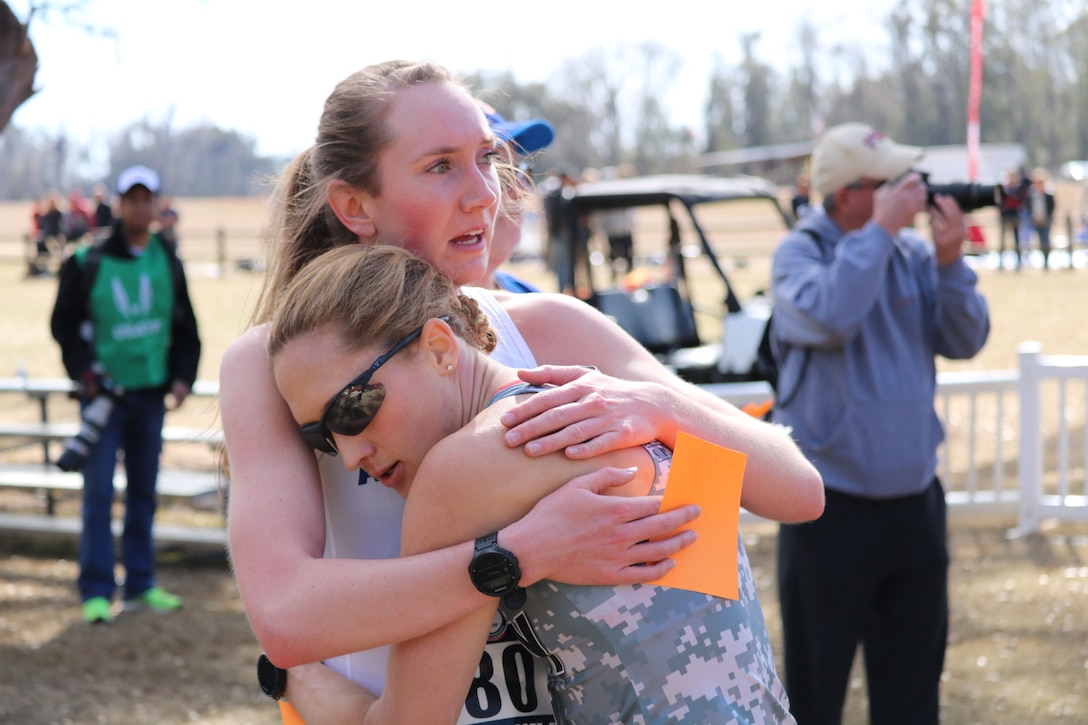 Air Force 2nd lt. Hannah Everson of Hurlburt Field, Florida and Army Maj. Kelly Calway of West Point, N.Y., congratulate each other after finishing 2nd and 3rd respectively during the 2018 Armed Forces Cross Country Championship