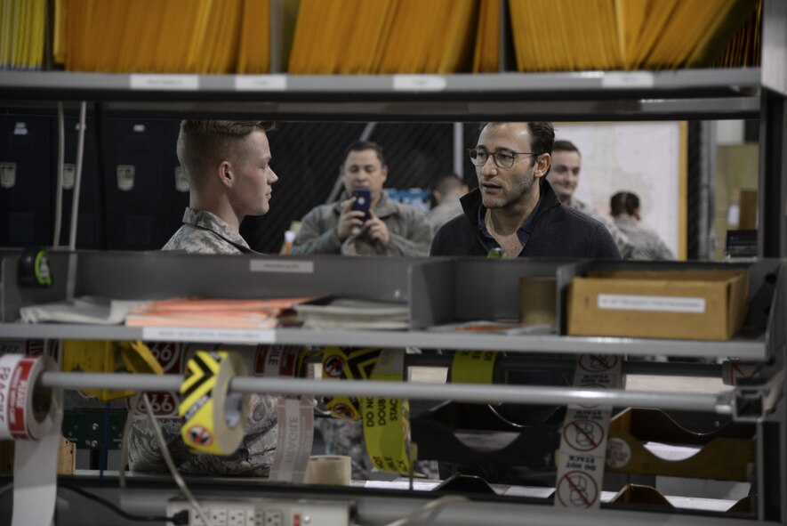 Senior Airman Atticus Hammonds, 436th Aerial Port Squadron traffic management specialist, explains the Super Port’s packing and crating process to Simon Sinek Feb. 1, 2018, at Dover Air Force Base, Del. Dover AFB is home to the Department of Defense’s largest aerial port. (U.S. Air Force photo by Staff Sgt. Aaron J. Jenne)