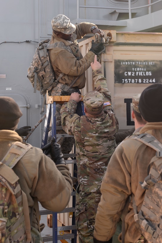 U.S. Army Staff Sgt. George Sulligan, boatswain, 1099th Transportation Detachment, 10th Battalion, 7th Transportation Brigade, teaches Sgt. Moryba Gbane, vehicle operator, 149th Seaport Operations Company, 10th Bn., 7th Trans. Bde. (Ex.)., the proper way to secure a container on Fort Eustis' 3rd Port at Joint Base Langley-Eustis, Va., Feb. 1, 2018. Stable and secure cargo was a key training element for the exercise. (U.S. Air Force photo by Airman 1st Class Monica Roybal)