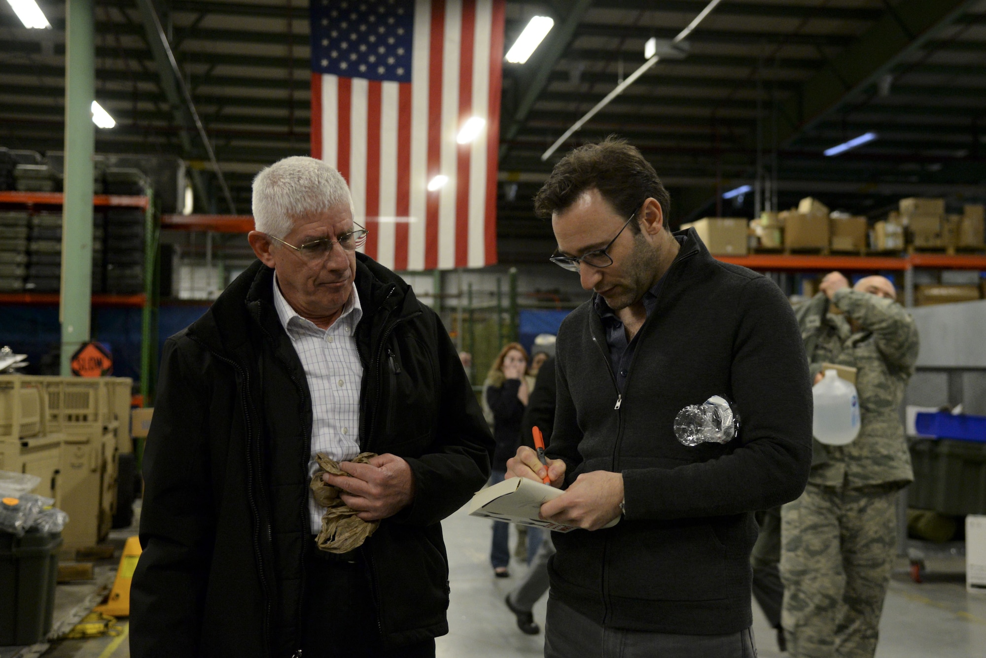 Simon Sinek signs a book for James Pacer, 436th Airlift Wing Transition Assistance Program manager, after a briefing with Team Dover customer service Airmen Feb. 1, 2018, at Dover Air Force Base, Del. Sinek explained the significance of good leadership and how it relates to the customer service experience. (U.S. Air Force photo by Staff Sgt. Aaron J. Jenne)