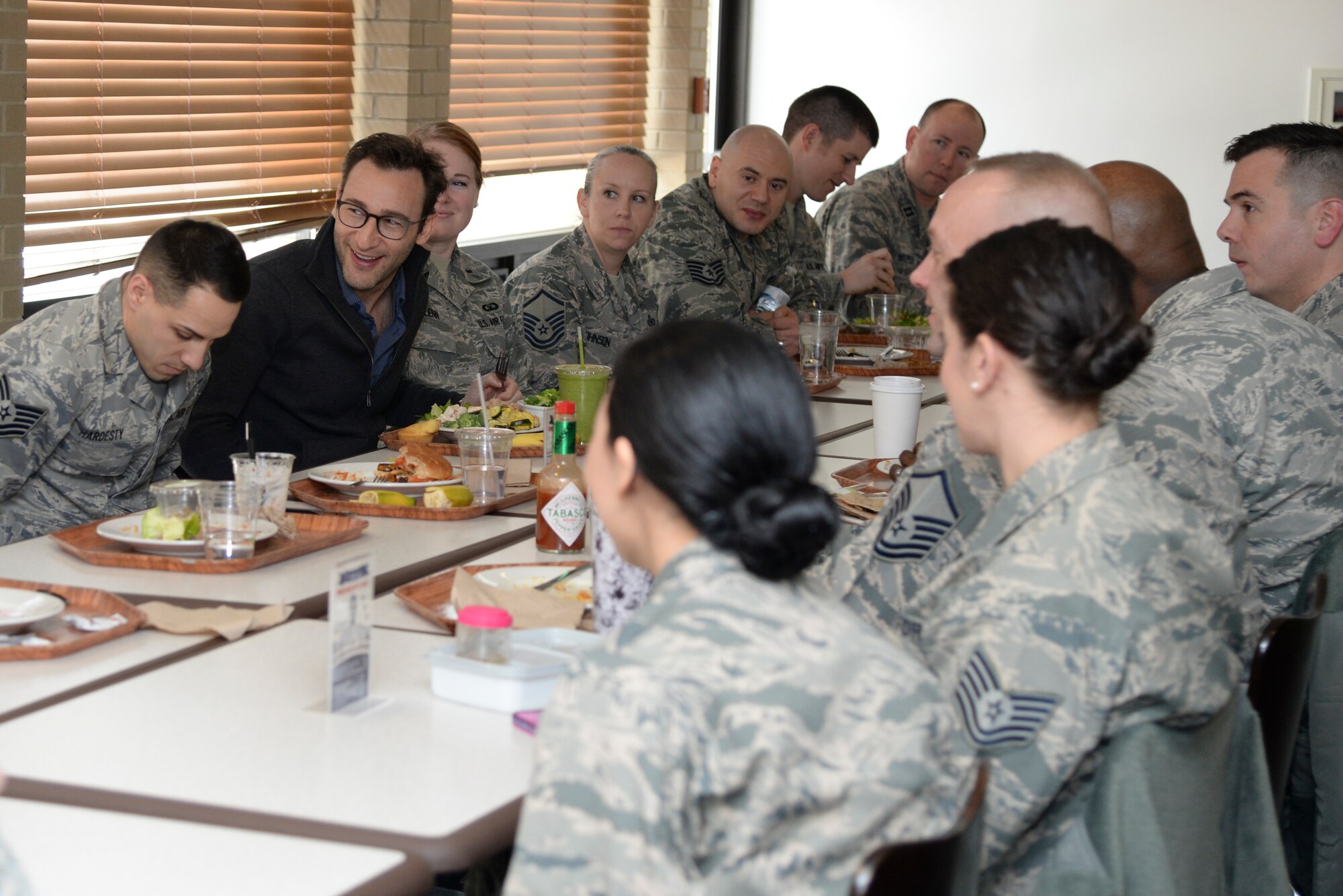 Simon Sinek shares lunch with Airmen Feb. 1, 2018, at the Patterson Dining Facility on Dover Air Force Base, Del. Team Dover NCOs, senior NCOs and company grade officers asked Sinek questions about his perspective on leadership and followership during the luncheon. (U.S. Air Force photo by Staff Sgt. Aaron J. Jenne)