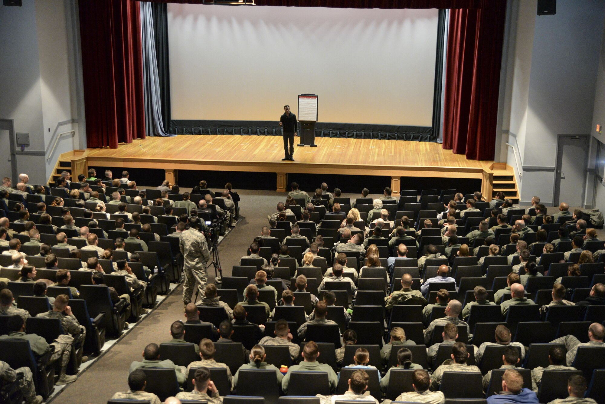 Simon Sinek speaks to the Airmen of Team Dover during an all call Feb. 1, 2018, at the base theater on Dover Air Force Base, Del. Sinek urged the Airmen of Dover AFB to live an “infinite life” by constantly pursuing personal growth. (U.S. Air Force photo by Staff Sgt. Aaron J. Jenne)