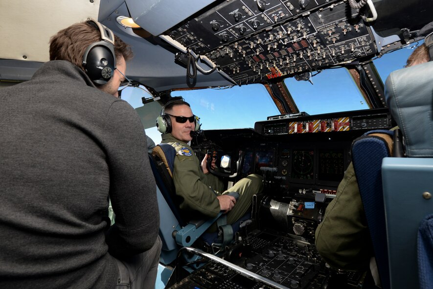 Lt. Col. Charles Throckmorton, 436th Operations Group deputy commander, talks with Simon Sinek from the pilot seat of a C-5M Super Galaxy Feb. 2, 2018. Sinek was invited to join the aerial refueling training mission to complete his tour of Dover Air Force Base. (U.S. Air Force photo by Staff Sgt. Aaron J. Jenne)