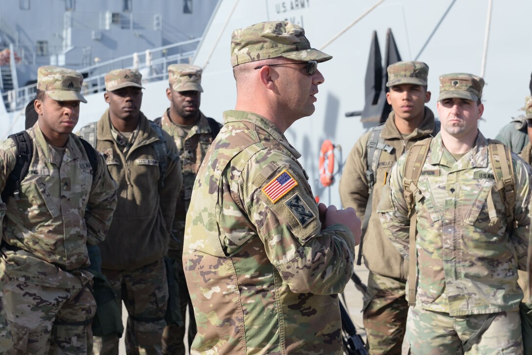 U.S. Army Staff Sgt. Christopher Davis, first mate, 97th Transportation Company, 10th Transportation Battalion, 7th Transportation Brigade (Expeditionary), delivers a safety briefing before a training exercise on Fort Eustis' 3rd Port at Joint Base Langley-Eustis, Va., Feb. 1, 2018. Members of the 149th Seaport Operations Company executed a roll-on, roll-off exercise where vehicles were loaded and unloaded onto a vessel. (U.S. Air Force photo by Airman 1st Class Monica Roybal)