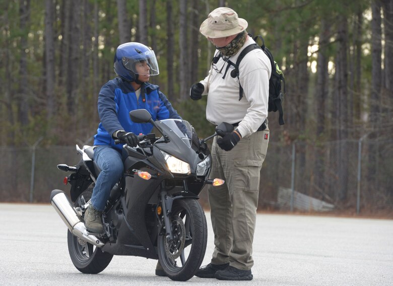 U.S. Air Force Airman 1st Class David Prado, left, 437th Aircraft Maintenance Squadron crew chief, receives instruction from Jeffery Phipps, right, a rider coach at Trident Technical College during a motorcycle safety course at Joint Base Charleston Naval Weapons Station, Feb. 4.