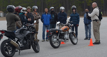Jeffery Phipps, far right, a rider coach from Trident Technical College, explains to students the next obstacle course requirements to students during a Basic Motorcycle Rider’s Course at Joint Base Charleston Naval Weapons Station, Feb. 4.