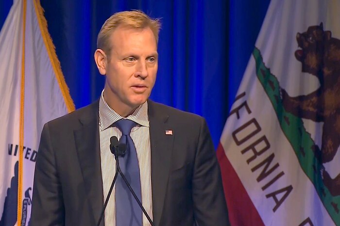 Deputy Defense Secretary Patrick M. Shanahan speaks into microphones.