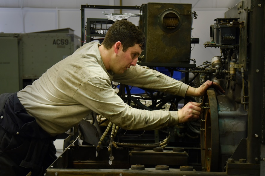 Senior Airman Dustin Holmes, 5th Maintenance Squadron aerospace ground equipment technician, checks the size of a bolt at Minot Air Force Base, N.D., Jan. 24, 2018. Aerospace ground equipment technicians are responsible for delivery, maintenance and inspection of equipment used on the flight line. (U.S. Air Force photo by Senior Airman Jessica Weissman)